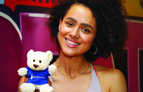 Nathalie Emmanuel with smile train stuffed animal
