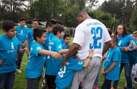 Kenyan Drake huddles with Smile Train patients in Mexico