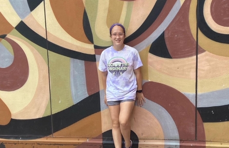 Grace Murphy smiles against a colorful wall