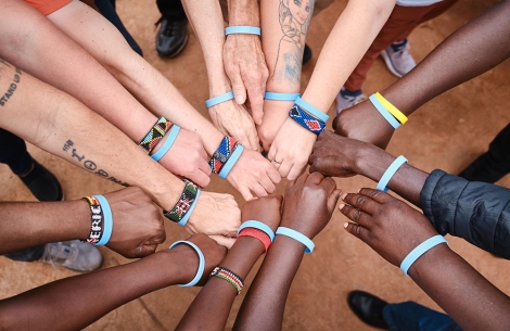 Journey of Smiles participants and Smile Train staff members join their fists together