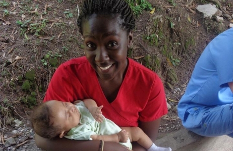 Christian Henry holds a baby in Honduras