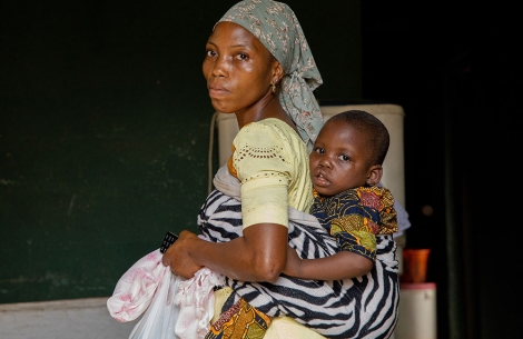 Opeyemi riding on his mother's back