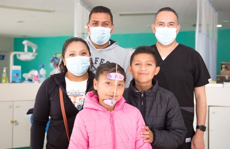 Alex, Kendra, their parents, and a member of their cleft team