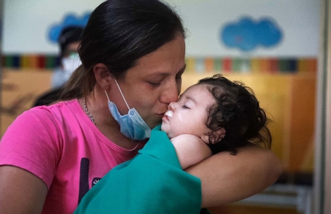 Maxi's mother holding him just after his free cleft surgery