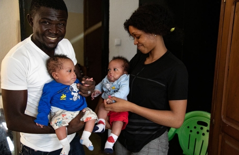 Audrey and Herve holding their twins, Lloyd and Floyd