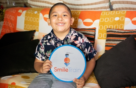 Ramses holding a Smile Train logo