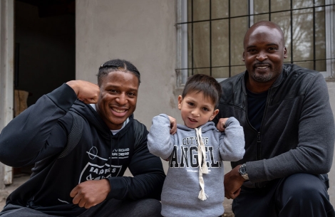 Kenyan Drake and Mathias Kiwanuka pose with a Smile Train patient in Argentina