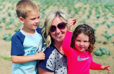 Miranda picking strawberries with her step-children