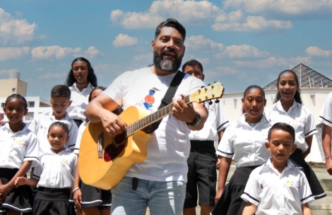 The cleft choir at Hospital Notti in Mendoza, Argentina, performing on a scenic riverbank