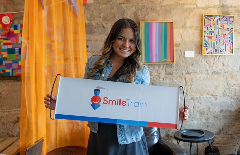 Tammy holding a Smile Train sign in Mexico