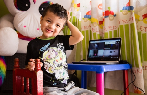 Alex smiling at his computer