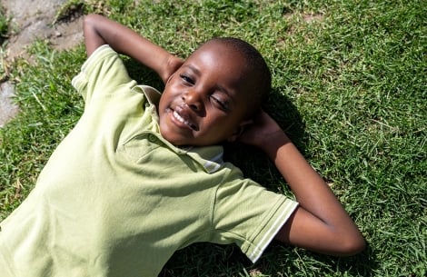 Wayne laying on the grass, looking at the sky