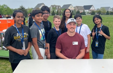 John Bates, tight end of the Washington Commanders, sharing a smile with members of the Leo Club