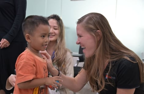 Sara Horne sharing a smile with a Smile Train patient