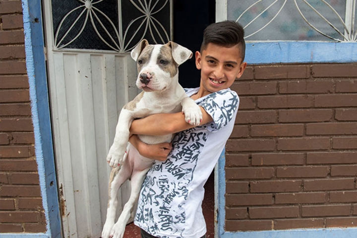 Cristian holds one of his dogs