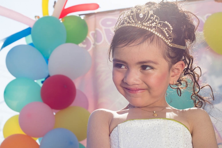 Alexa wearing her tiara and surrounded by colorful ballons