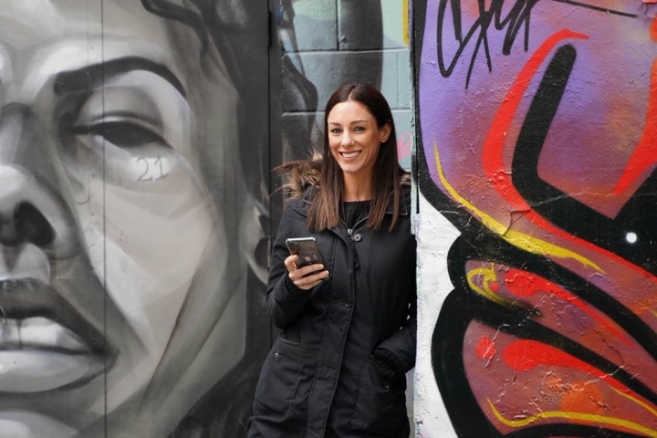 Christine Smessaert in front of graffiti