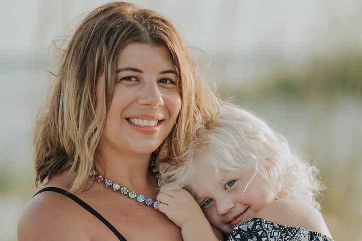 Cleft community advisory council member holding her child