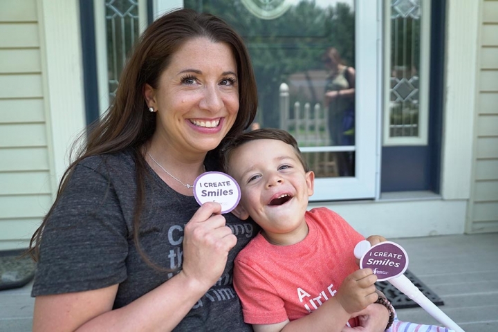 Mom and son smiling with I create smiles sticker