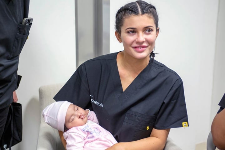 Kylie Jenner holding a baby with cleft