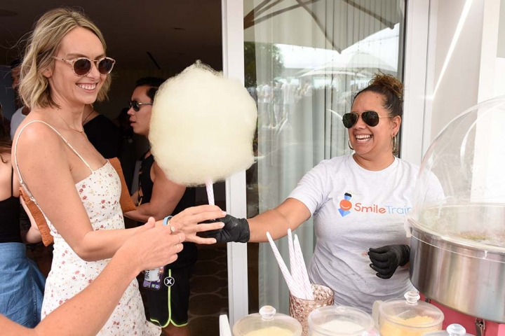 Smile Train volunteer handing out cotton candy