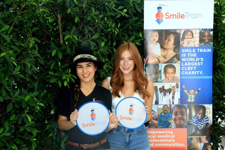 two young leadership circle members holding signs