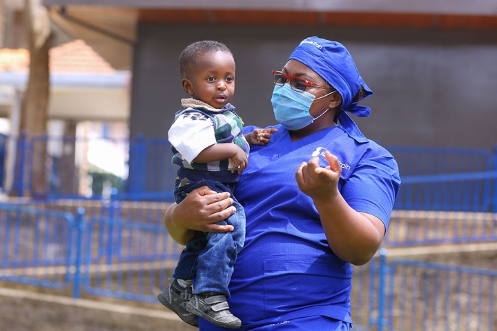 Dr. Amanda Malungo holding a cleft patient after his surgery.