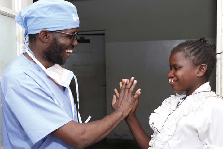 doctor high fiving cleft patient