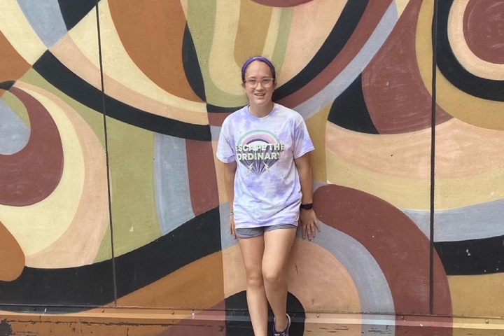 Grace Murphy smiles against a colorful wall