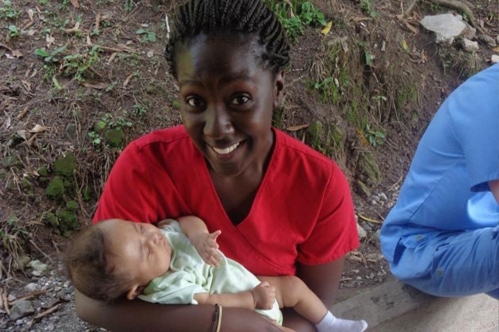 Christian Henry holds a baby in Honduras