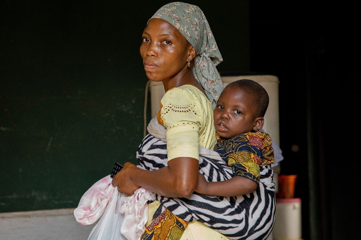 Opeyemi riding on his mother's back