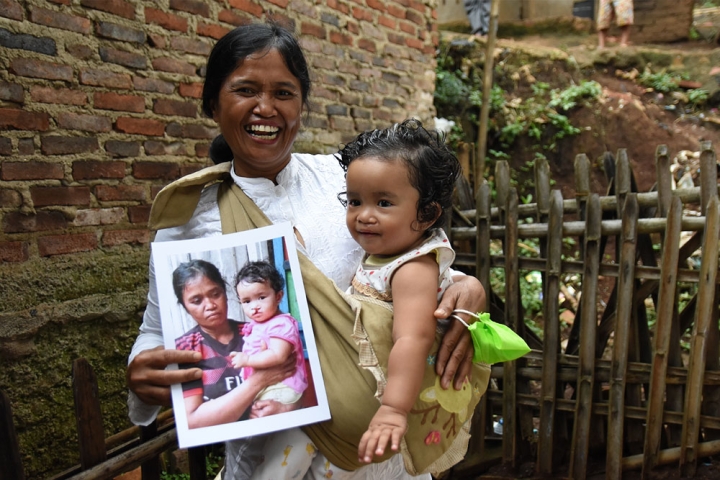 woman holding child and before and after photo