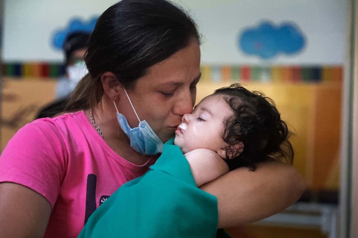 Maxi's mother holding him just after his free cleft surgery