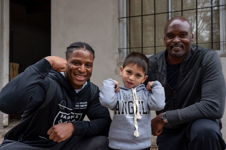 Kenyan Drake and Mathias Kiwanuka pose with a Smile Train patient in Argentina