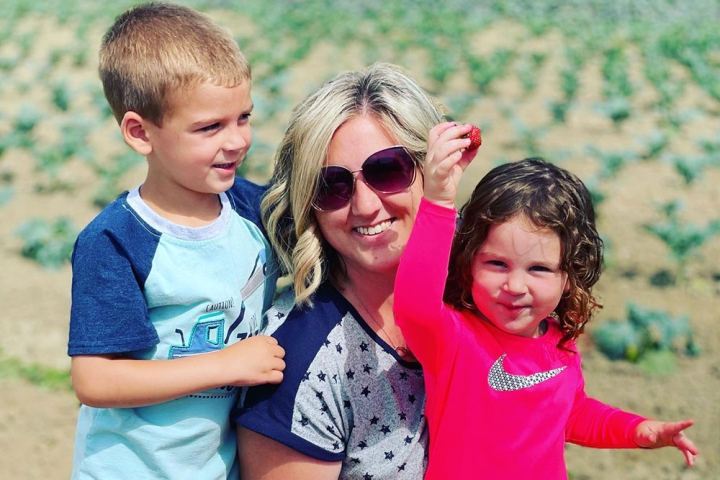 Miranda picking strawberries with her step-children