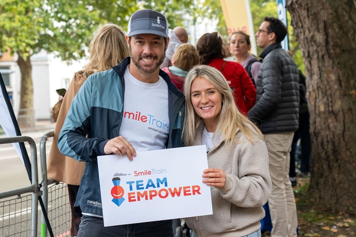 Candace Mauck and Troy Reinhart smiling at a Team Empower event