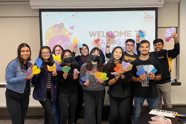 Members of Project Dental All posing with their origami heart cards