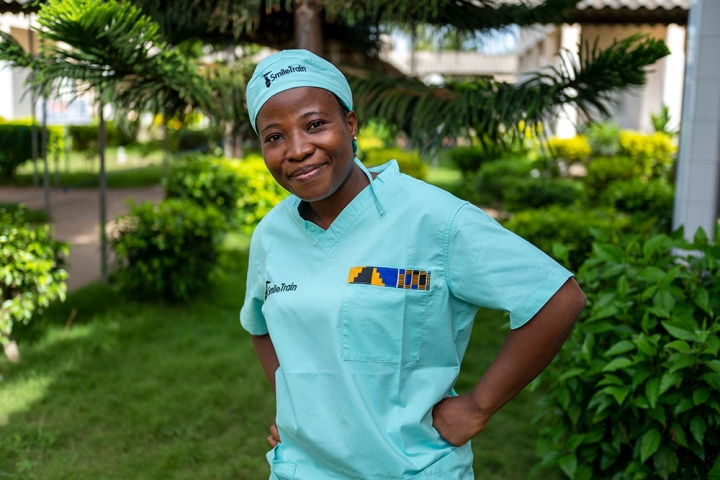 Dr. Sanni looking to the camera in Smile Train scrubs