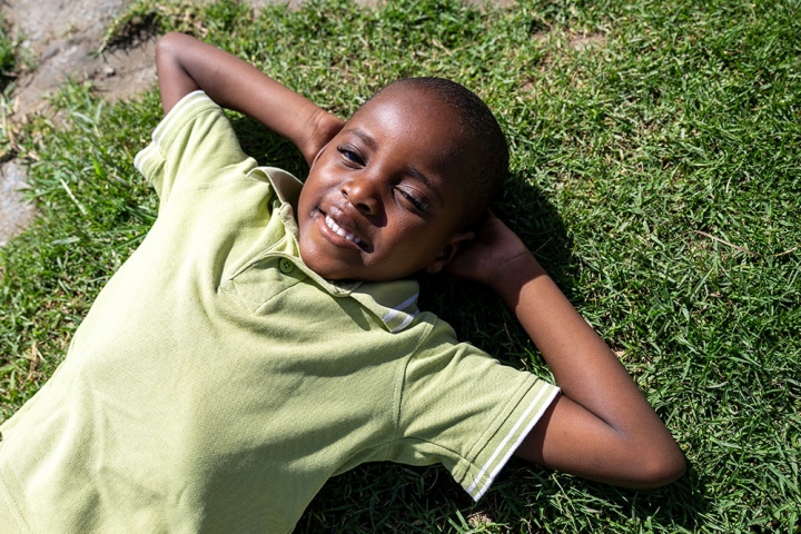 Wayne laying on the grass, looking at the sky