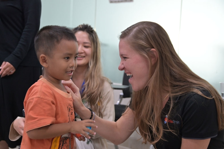 Sara Horne sharing a smile with a Smile Train patient