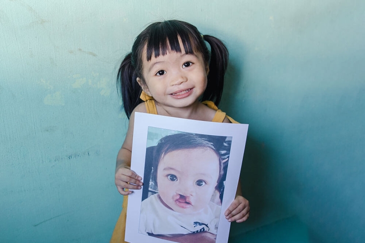 Zabriena holding a before picture of herself