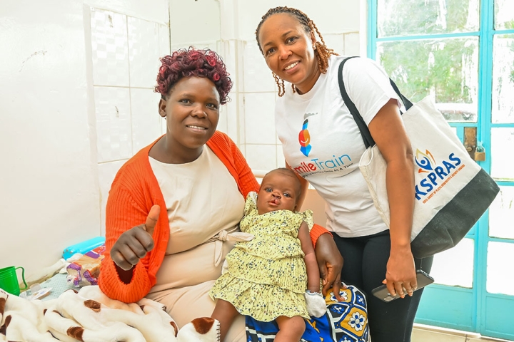 A mother with her baby and a Smile Train partner at a World Cleft Awareness Day event in Kenya