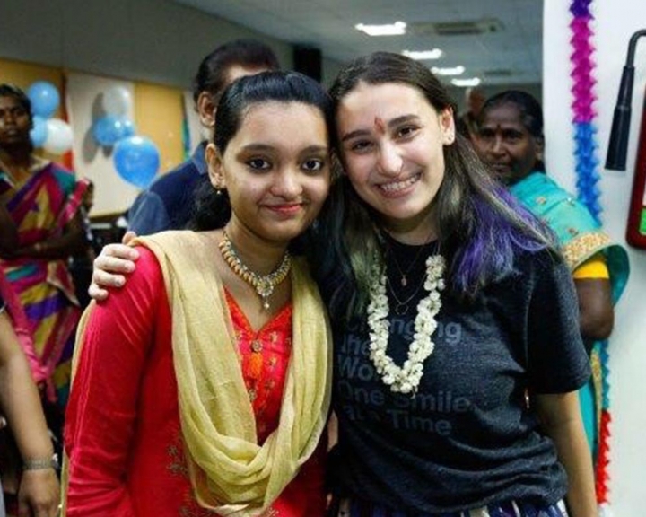 Andi poses with a Smile Train patient from India