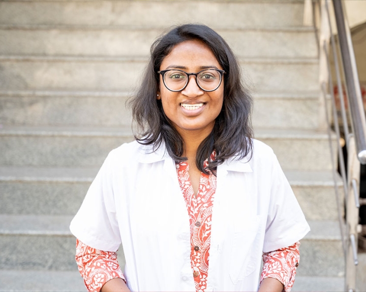 Dr. Mayuri Kalyanpad smiling in a lab coat after cleft surgery