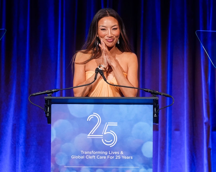Jeannie Mai speaking from the podium at Smile Train's 25th-Anniversary Gala