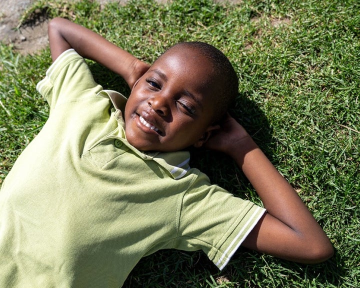 Wayne laying on the grass, looking at the sky