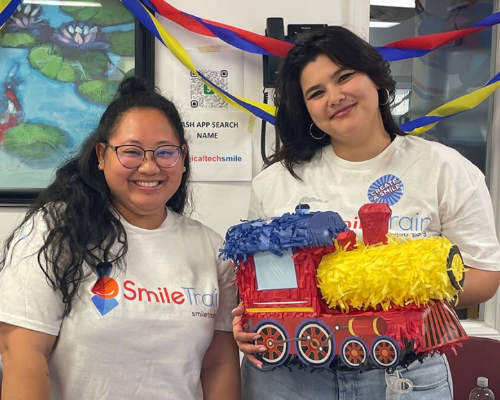 Smile Train supporters holding a train pinata