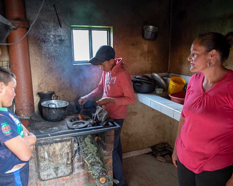 Neitan watches his brother cook over fire