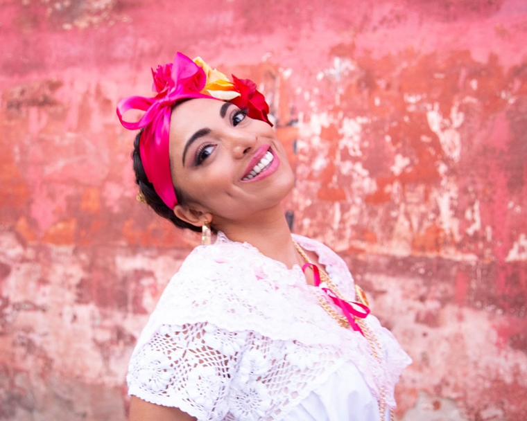 Adahara smiling dressed in traditional Mexican garb.