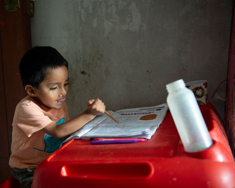 Anghelo sitting at his drawing desk.